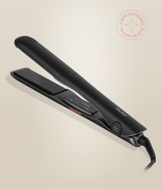 Astral Black Omnia Styler Plus lying open, with its plates and control panel visible.